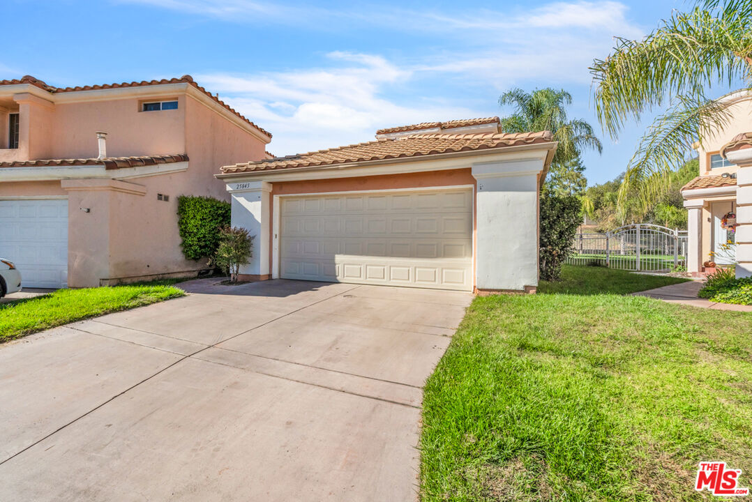 25845 Browning Place Stevenson Ranch, CA 91381 - Photo 2 of 36 a view of a house with a yard and plants