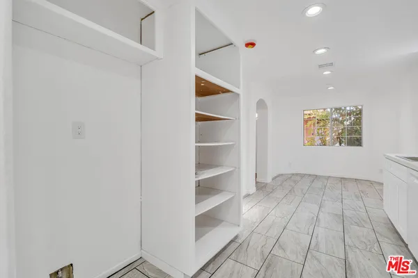 a view of a livingroom with wooden floor and a window