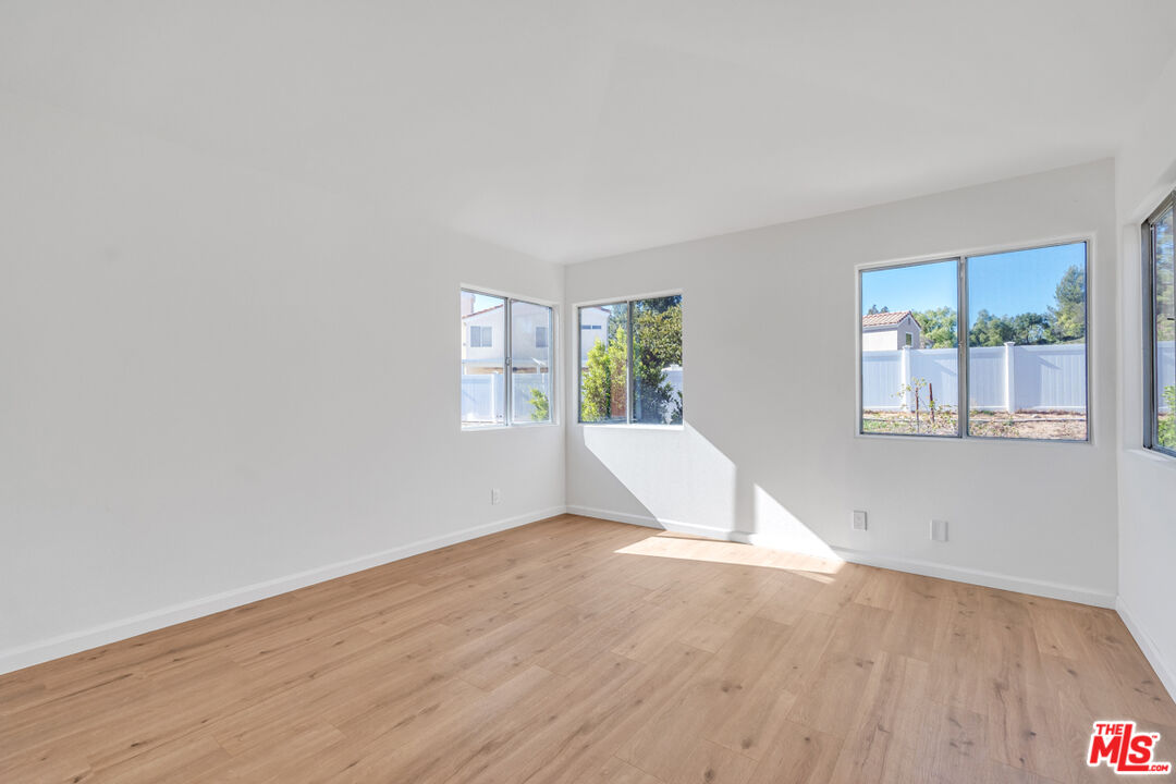 25845 Browning Place Stevenson Ranch, CA 91381 - Photo 22 of 36 a view of a livingroom with wooden floor and a window
