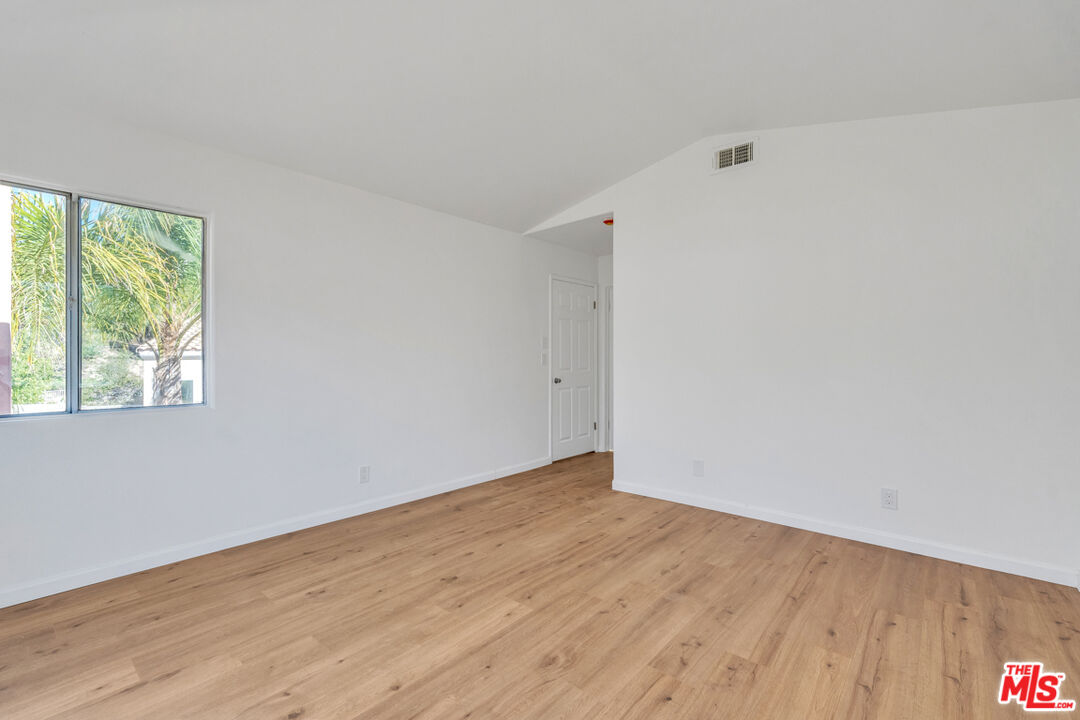 25845 Browning Place Stevenson Ranch, CA 91381 - Photo 23 of 36 an empty room with wooden floor and windows