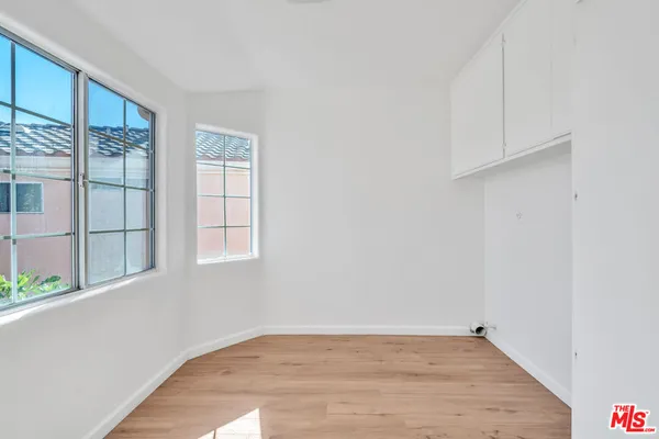 a view of an empty room with wooden floor
