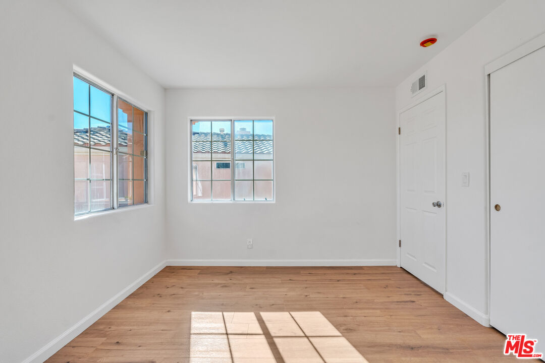 25845 Browning Place Stevenson Ranch, CA 91381 - Photo 31 of 36 a view of an empty room with wooden floor and a window