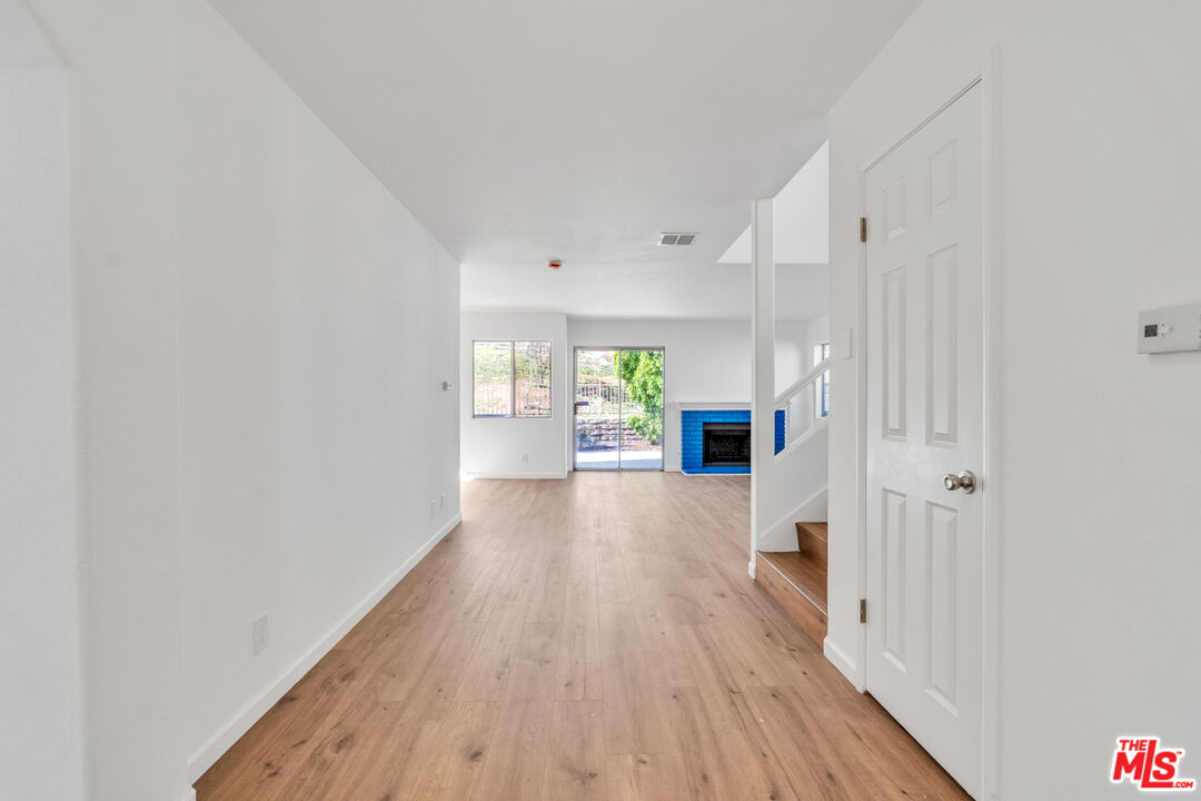 25845 Browning Place Stevenson Ranch, CA 91381 - Photo 7 of 36 a view of a kitchen with wooden floor and a window