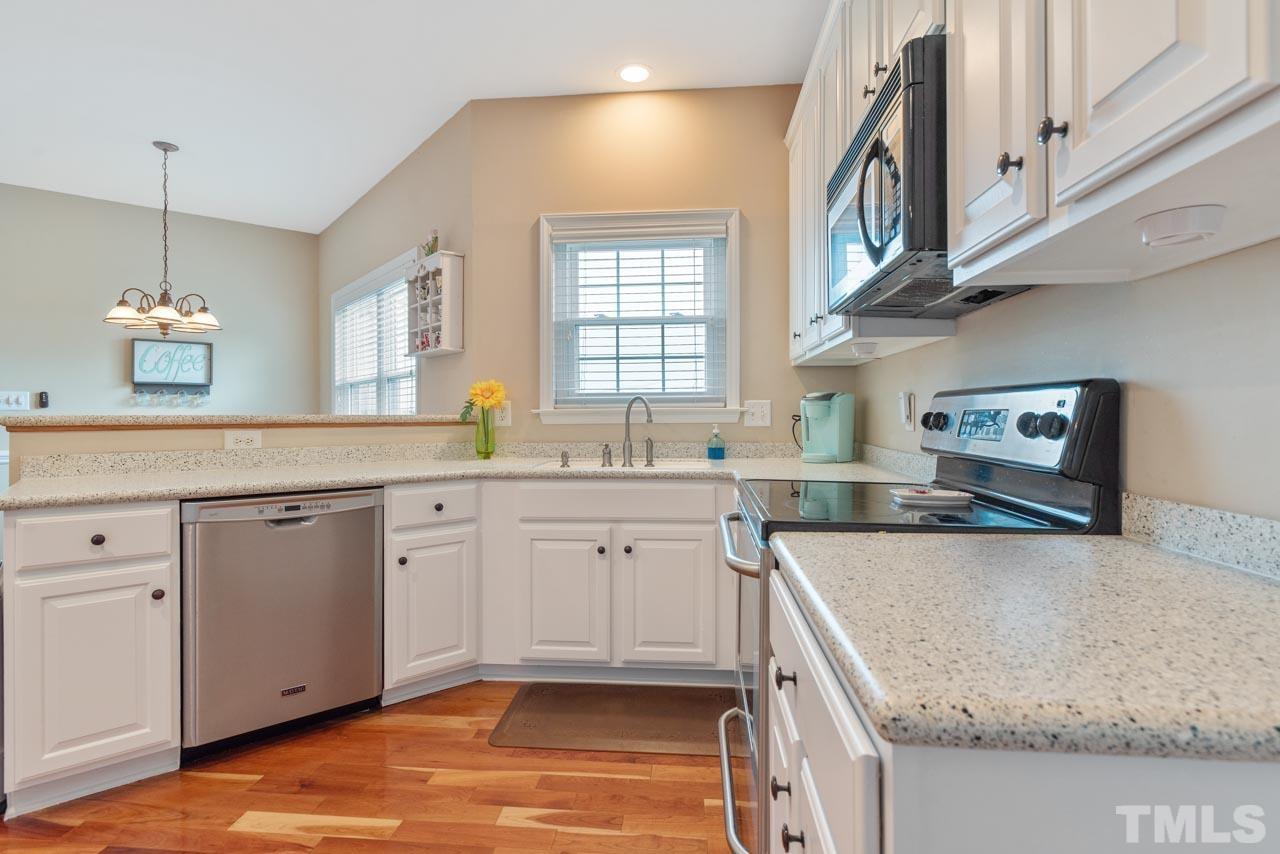468 Seastone Street Raleigh, NC 27603 - Photo 15 of 28 a kitchen with a sink stove and cabinets
