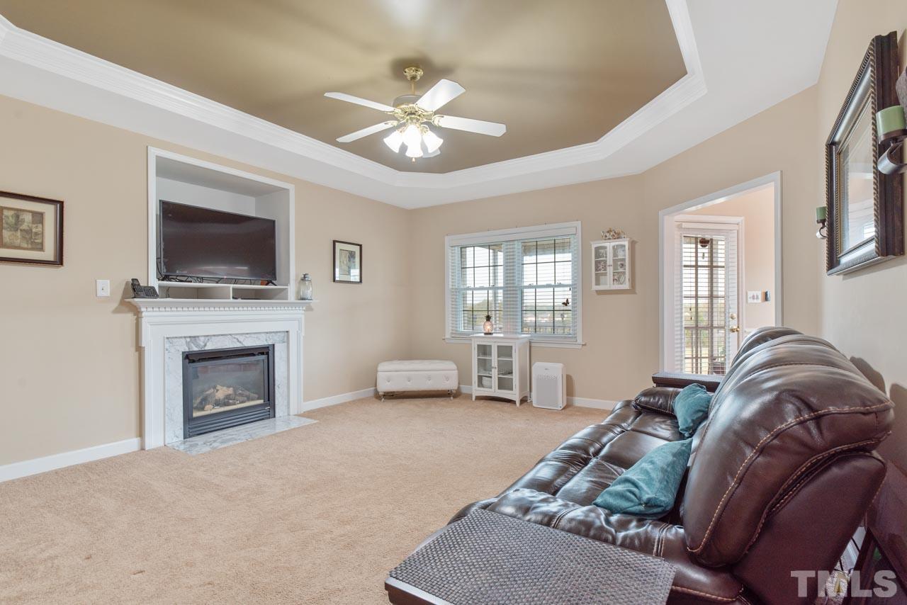 468 Seastone Street Raleigh, NC 27603 - Photo 17 of 28 a living room with furniture and a fireplace