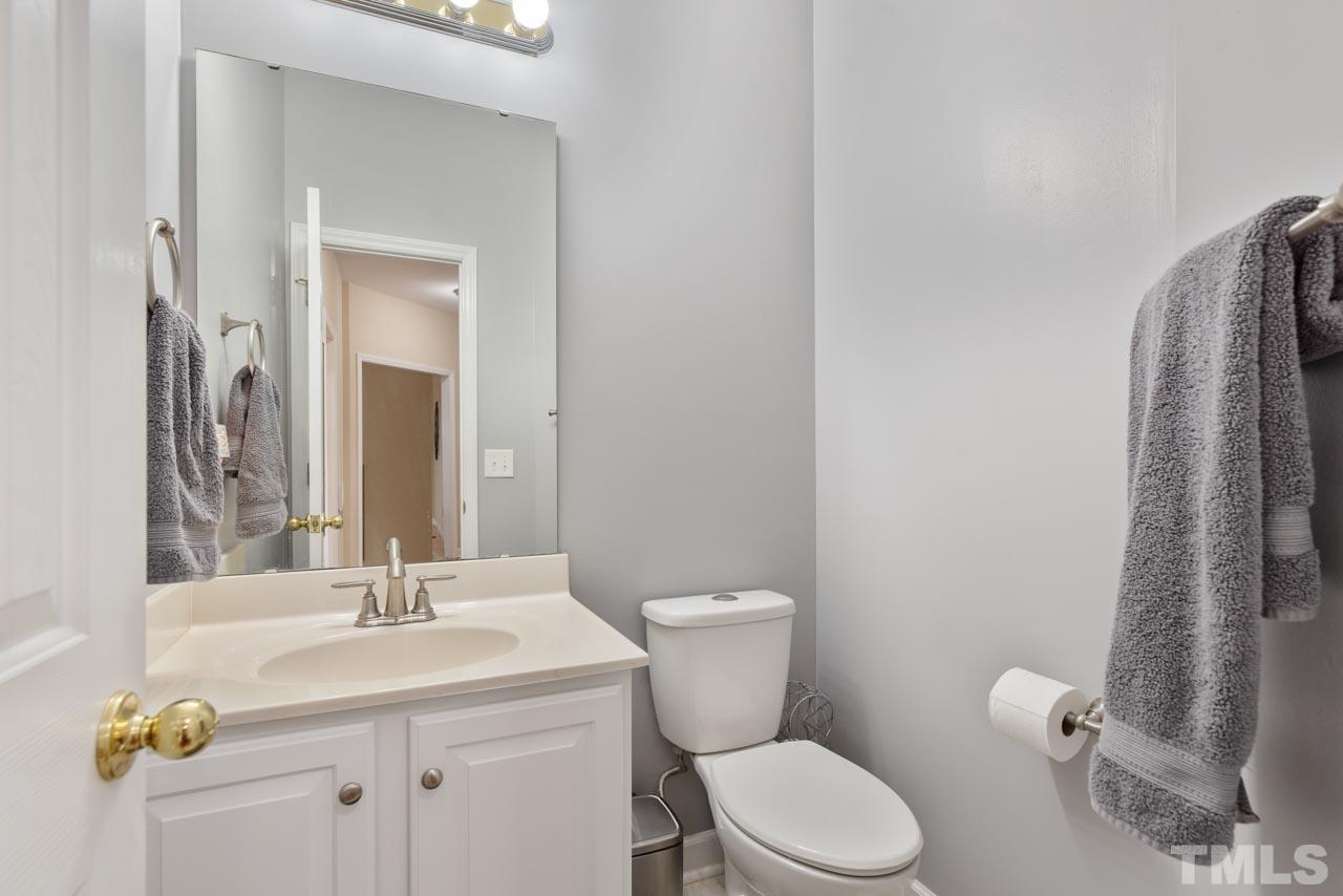 468 Seastone Street Raleigh, NC 27603 - Photo 19 of 28 a bathroom with a sink toilet and mirror