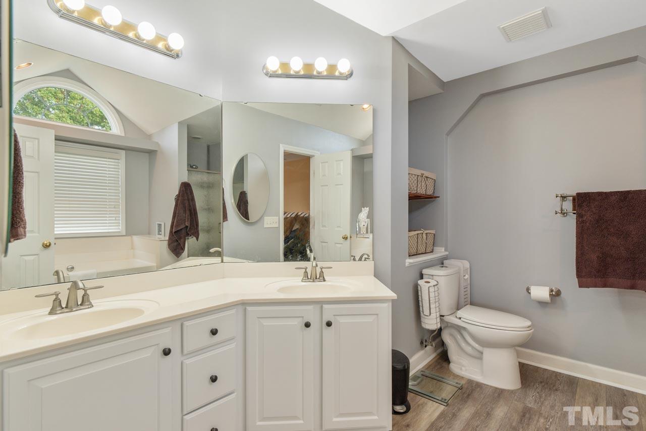 468 Seastone Street Raleigh, NC 27603 - Photo 24 of 28 a bathroom with a toilet sink and mirror