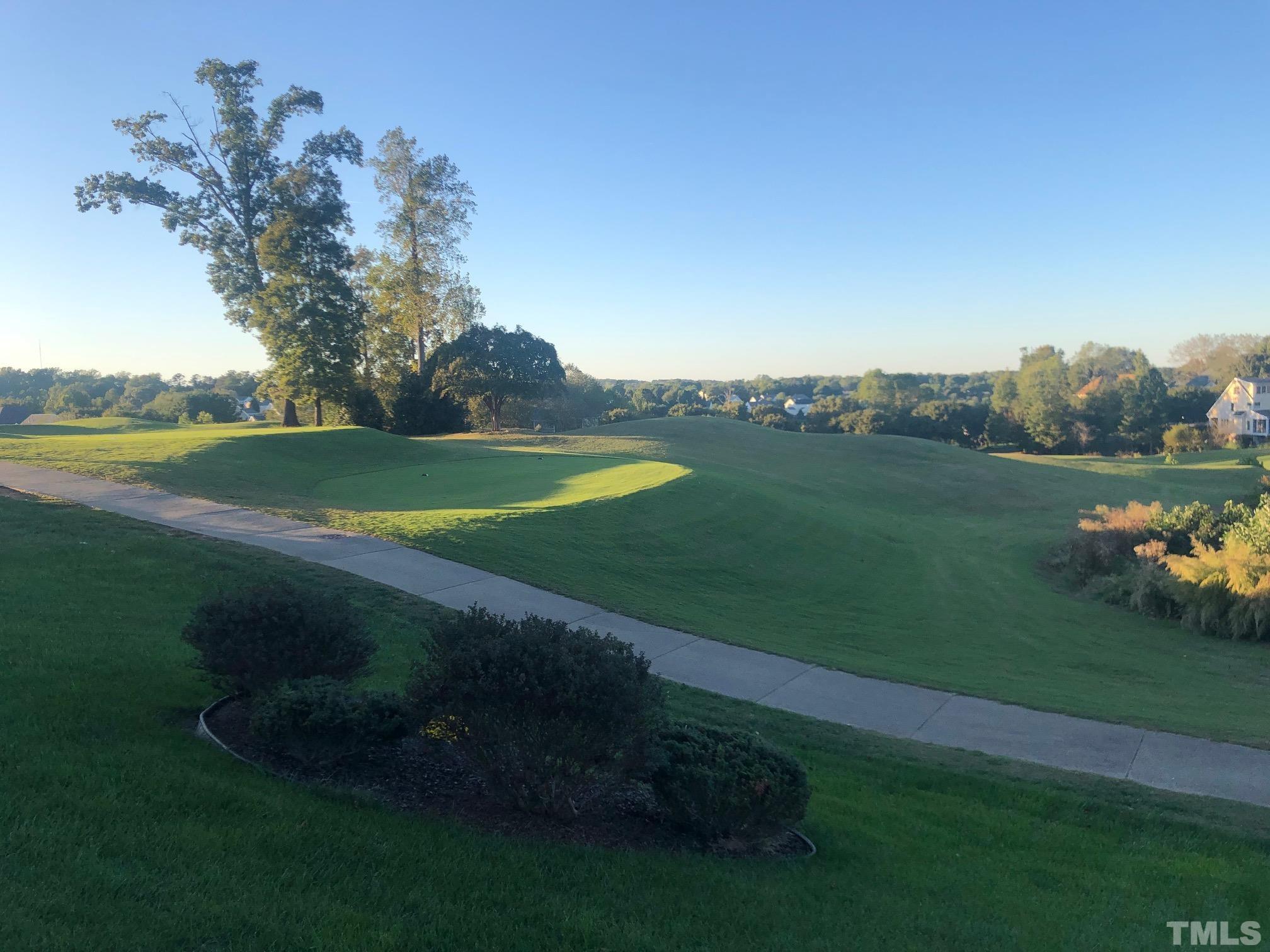 468 Seastone Street Raleigh, NC 27603 - Photo 5 of 28 a view of a golf course with a lake
