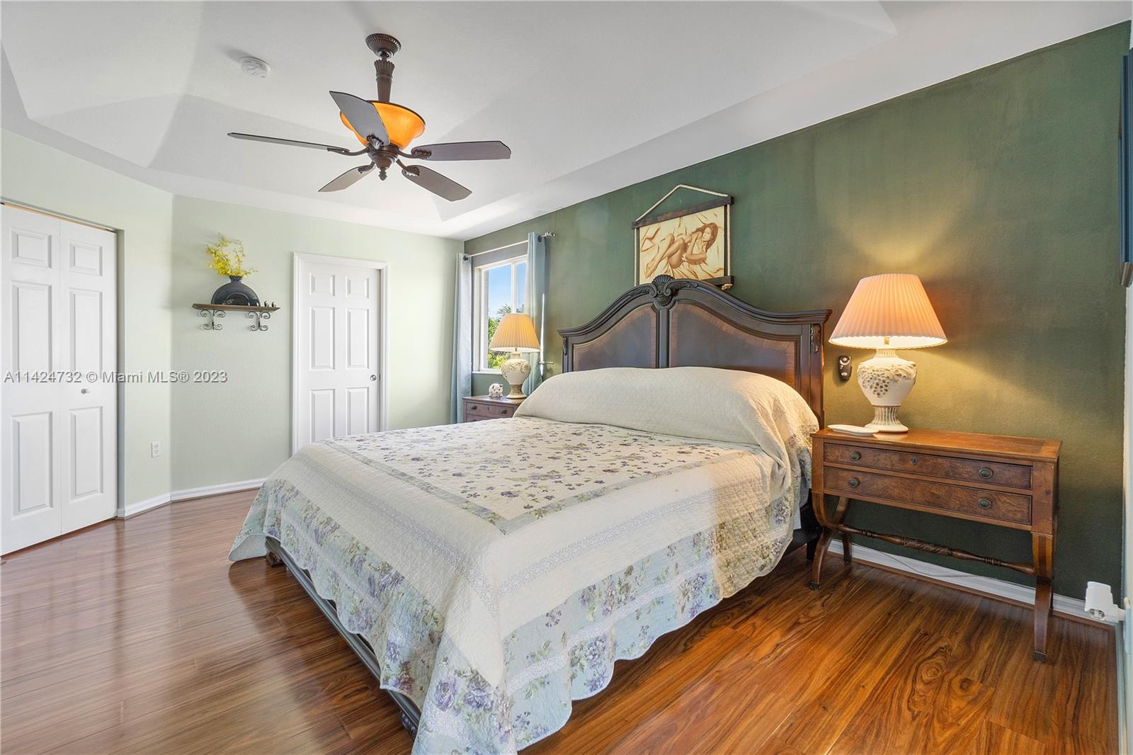 Silver Falls Miramar, FL 33027 - Photo 20 of 49 a spacious bedroom with a bed and a chandelier