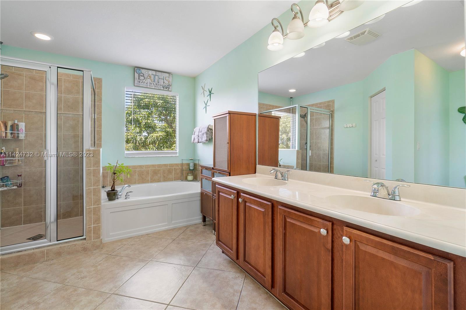 Silver Falls Miramar, FL 33027 - Photo 22 of 49 a spacious bathroom with a tub sink shower and mirror