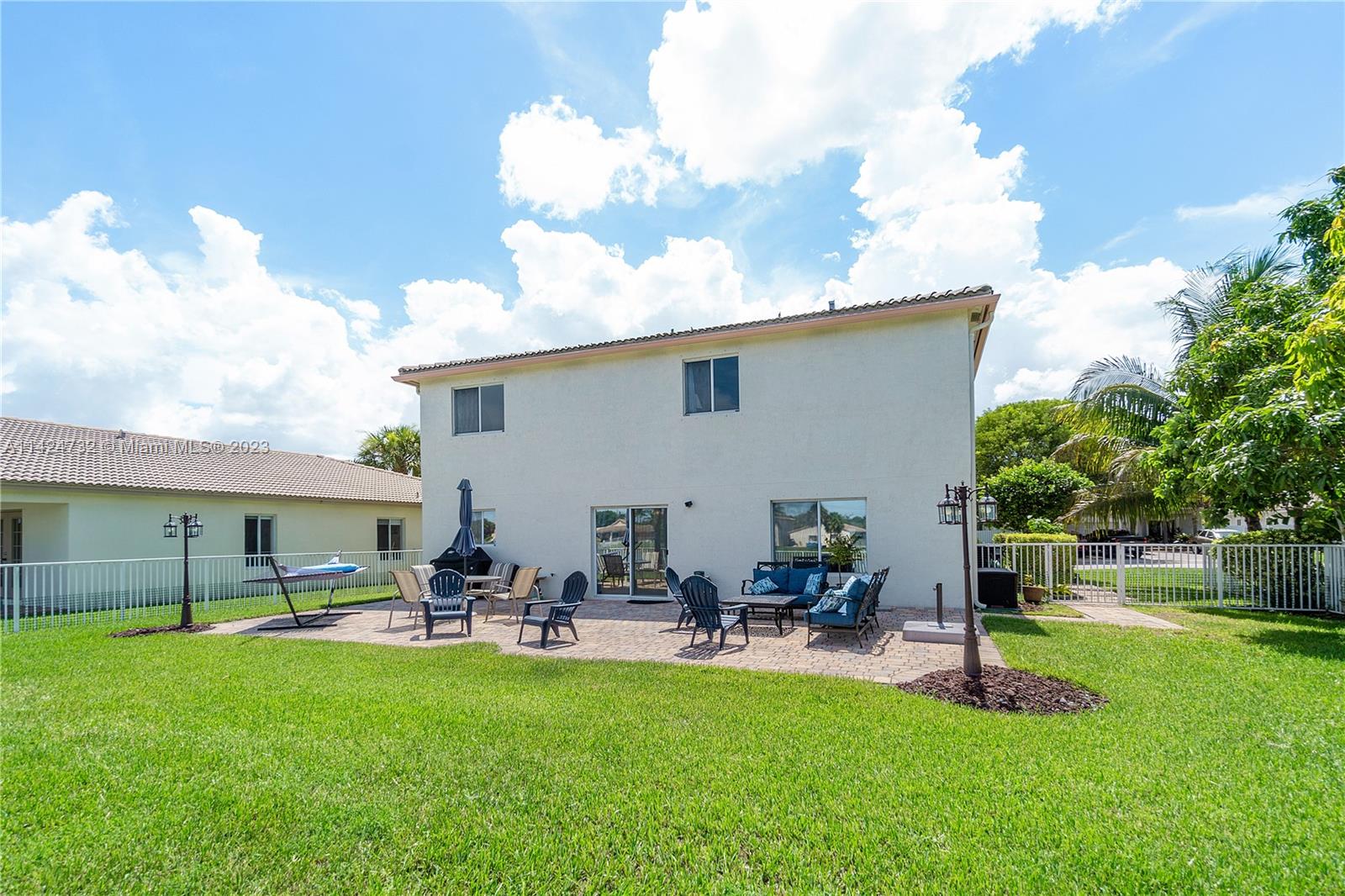 Silver Falls Miramar, FL 33027 - Photo 34 of 49 a view of a patio with table and chairs with a yard