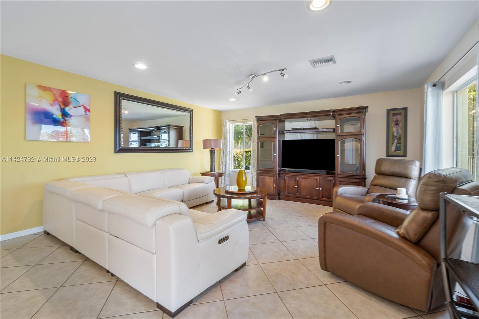 Silver Falls Miramar, FL 33027 - Photo 8 of 49 a living room with furniture and a flat screen tv