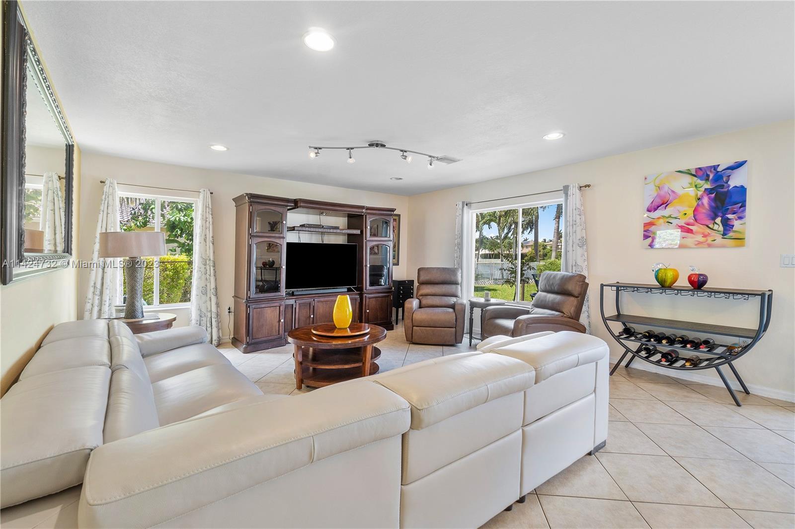 Silver Falls Miramar, FL 33027 - Photo 9 of 49 a living room with furniture and a flat screen tv
