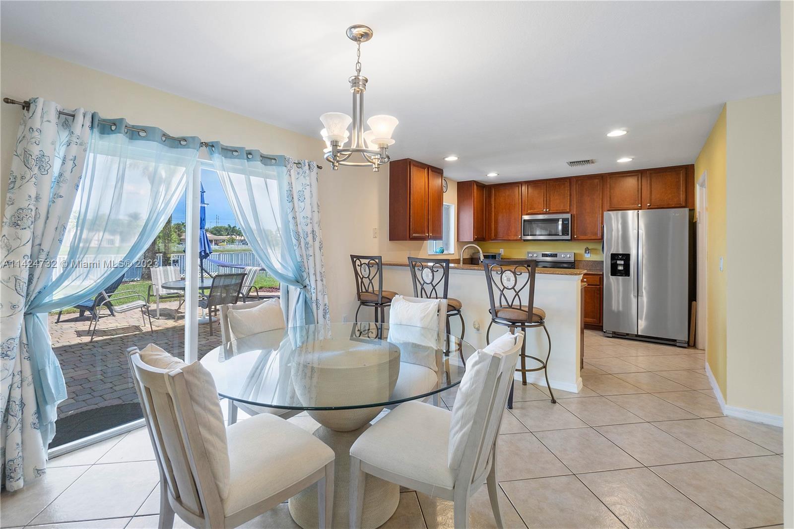 Silver Falls Miramar, FL 33027 - Photo 10 of 49 a dining room filled counter top space and a kitchen view