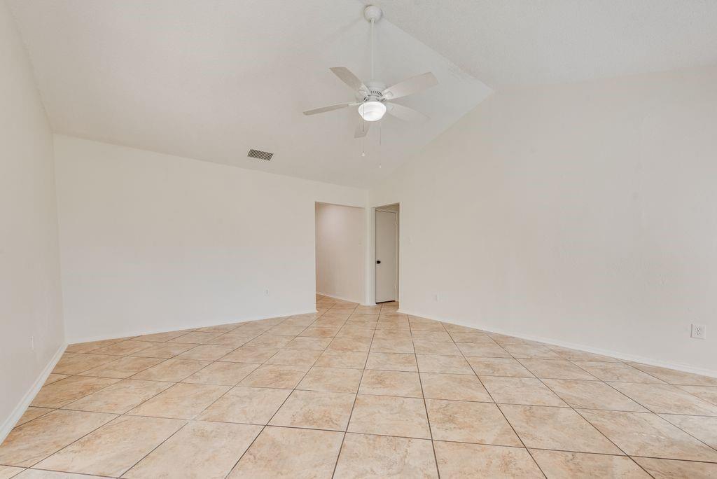 1532 Augusta Road Benbrook, TX 76126 - Photo 15 of 31 Spare room featuring lofted ceiling, ceiling fan, and light tile patterned floors