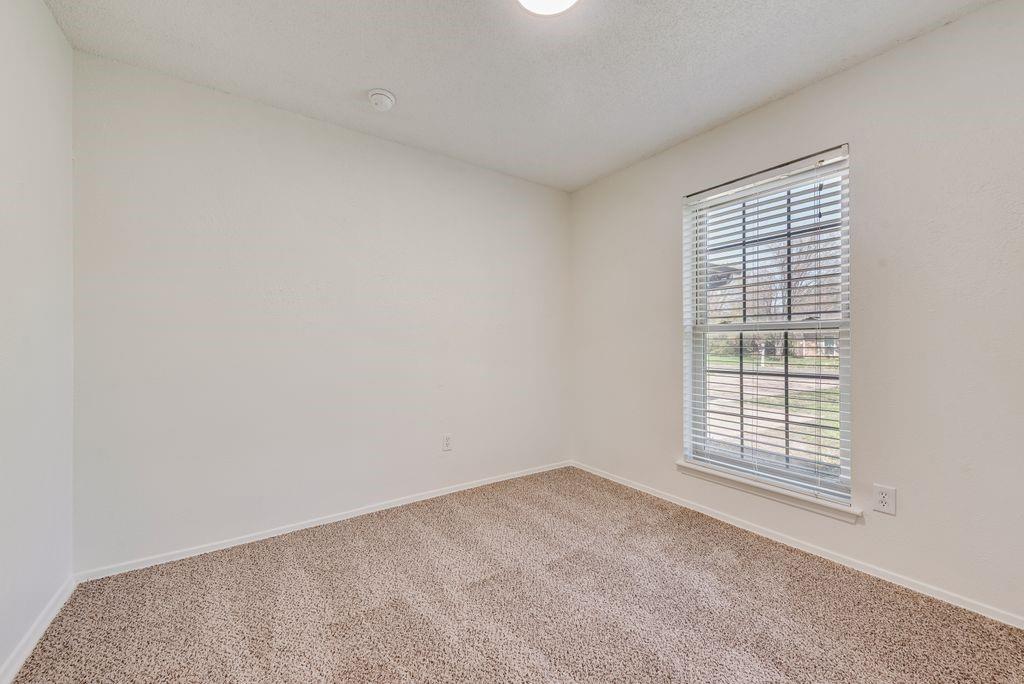 1532 Augusta Road Benbrook, TX 76126 - Photo 20 of 31 Carpeted spare room with baseboards and a textured ceiling