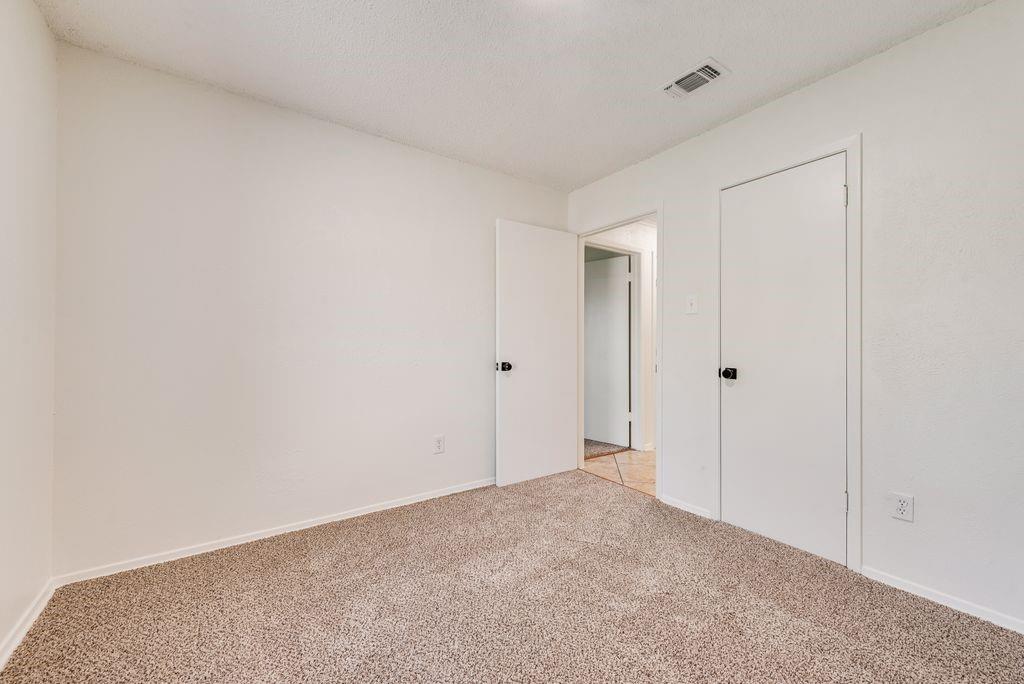 1532 Augusta Road Benbrook, TX 76126 - Photo 21 of 31 Unfurnished bedroom with light colored carpet and baseboards