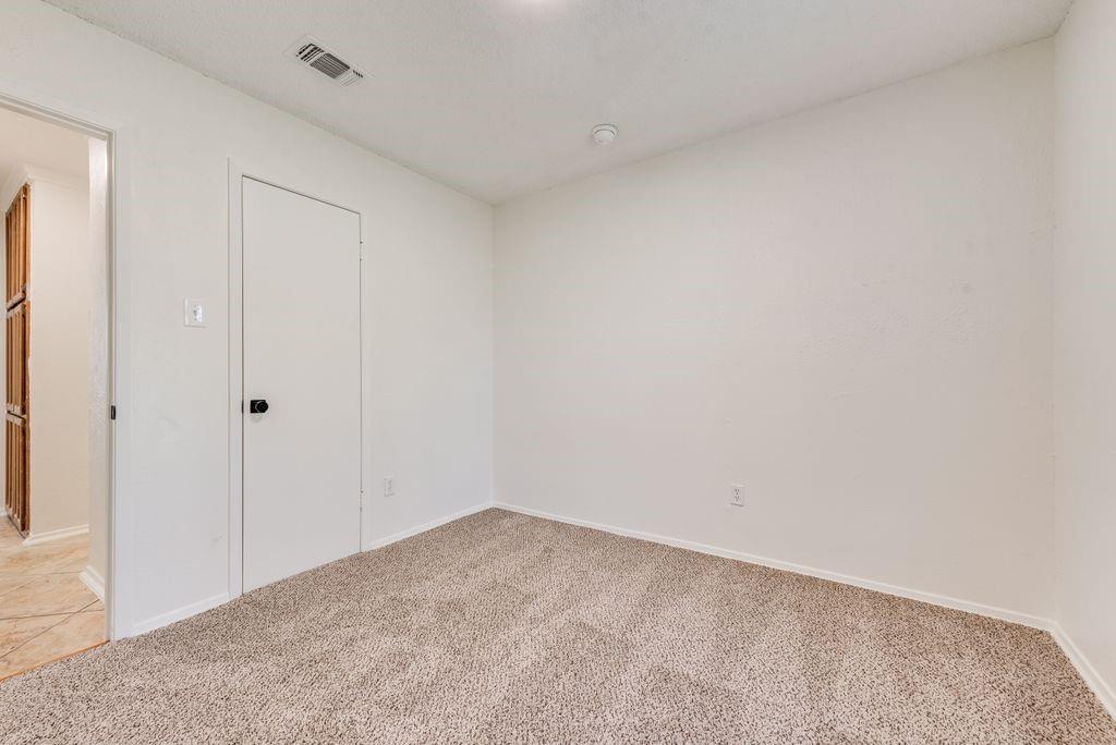 1532 Augusta Road Benbrook, TX 76126 - Photo 23 of 31 Spare room featuring baseboards and light carpet