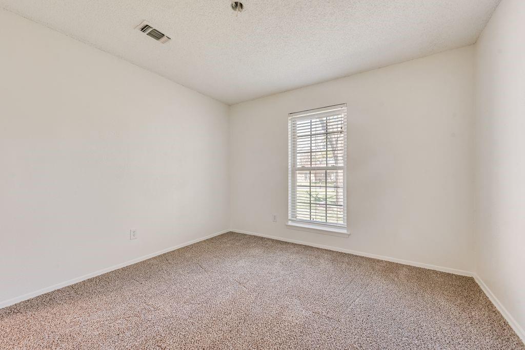 1532 Augusta Road Benbrook, TX 76126 - Photo 25 of 31 Empty room with a textured ceiling and light colored carpet