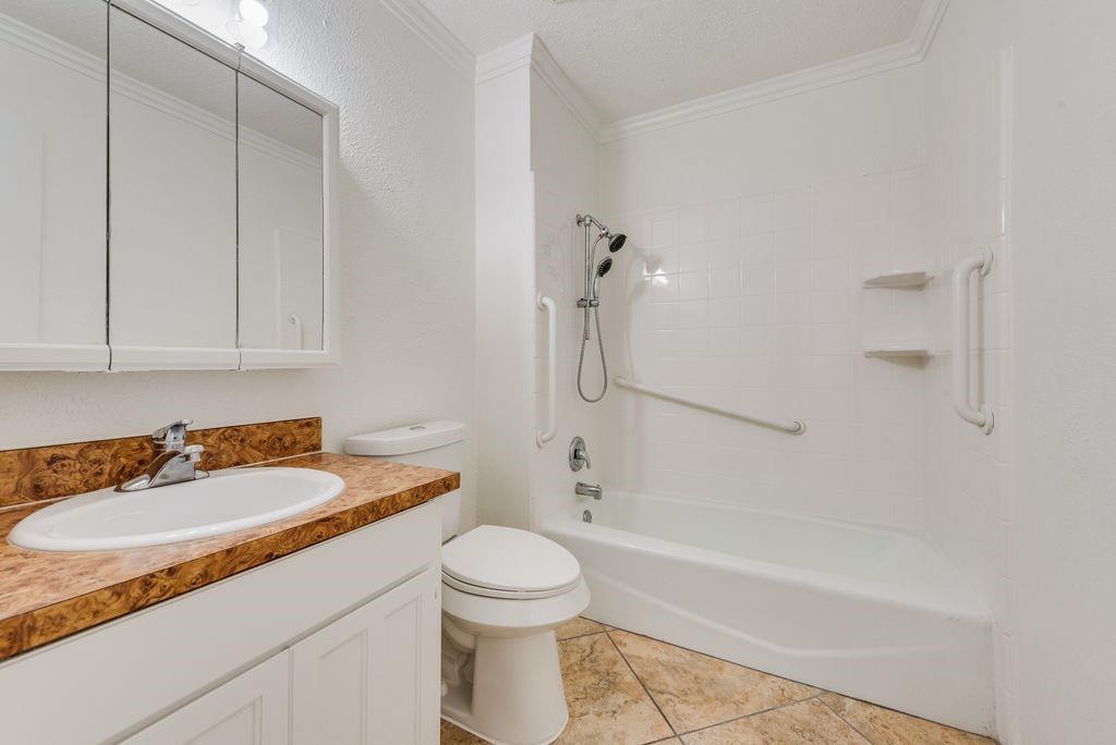 1532 Augusta Road Benbrook, TX 76126 - Photo 26 of 31 Bathroom featuring vanity, ornamental molding, shower / washtub combination, and light tile patterned flooring