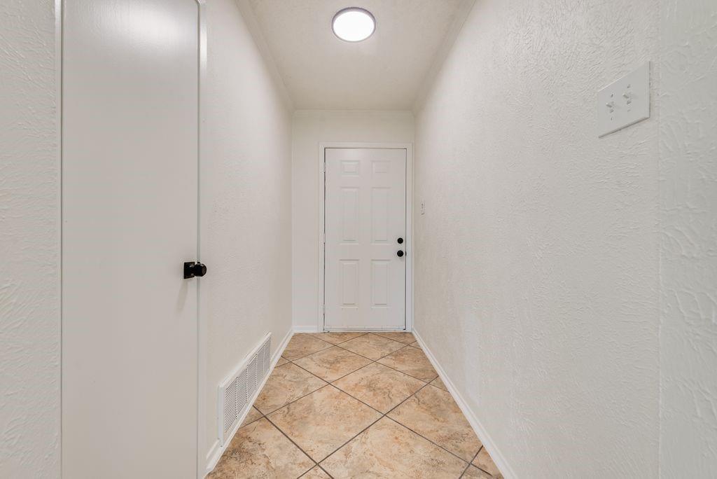 1532 Augusta Road Benbrook, TX 76126 - Photo 27 of 31 Entrance Hallway with a textured wall and light tile patterned floors