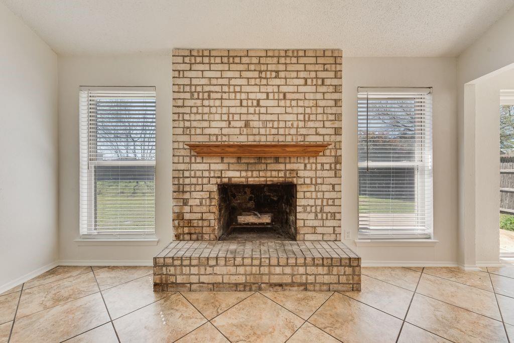 1532 Augusta Road Benbrook, TX 76126 - Photo 6 of 31 Detailed view of a brick fireplace and a textured ceiling