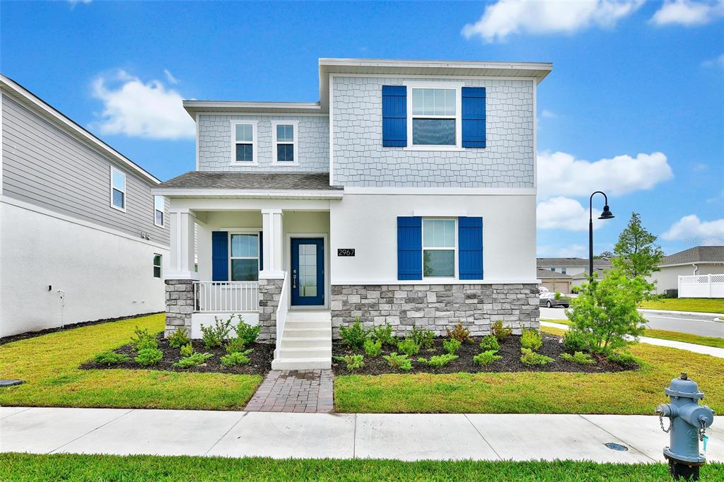 2967 Addison Boulevard St. Cloud, FL 34771 - Photo 1 of 1 a front view of a house with a yard and garage