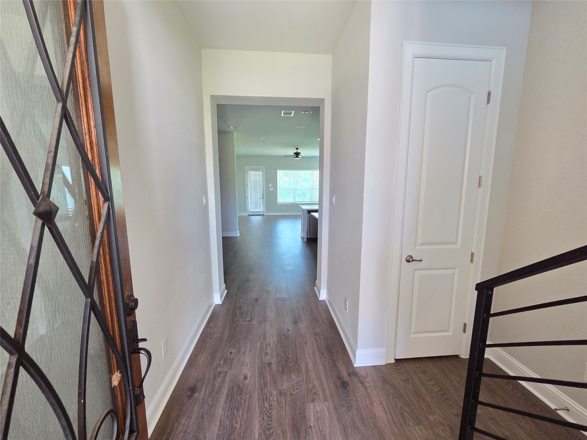 600 C-Bar Ranch Trail, Unit 121 Cedar Park, TX 78613 - Photo 8 of 32 A welcoming entryway with rich wood-look flooring extends towards the sun-lit living area.