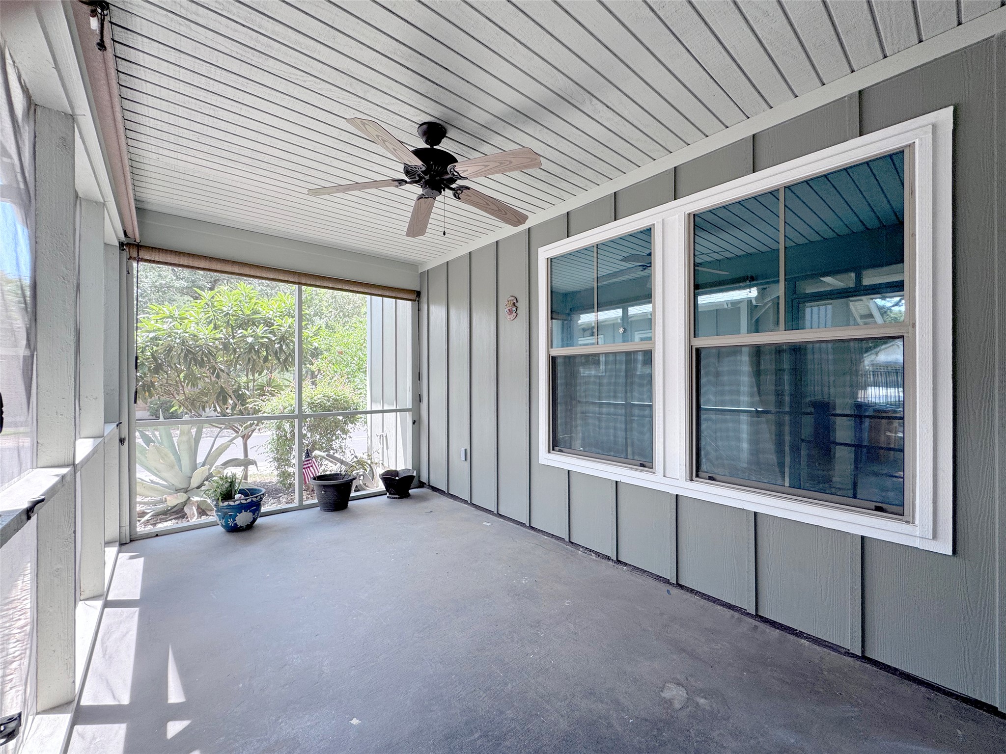 9707 Anderson Mill Road, Unit 21 Austin, TX 78750 - Photo 4 of 27 Concrete flooring and high paneled ceilings define this screened porch space.
