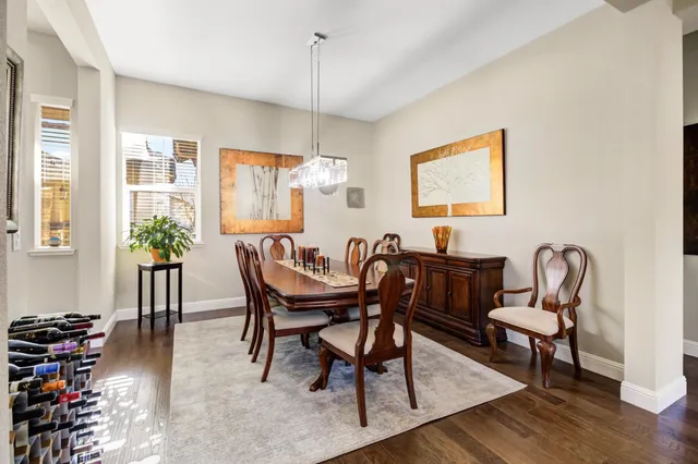 a view of a a dining room with furniture window and wooden floor