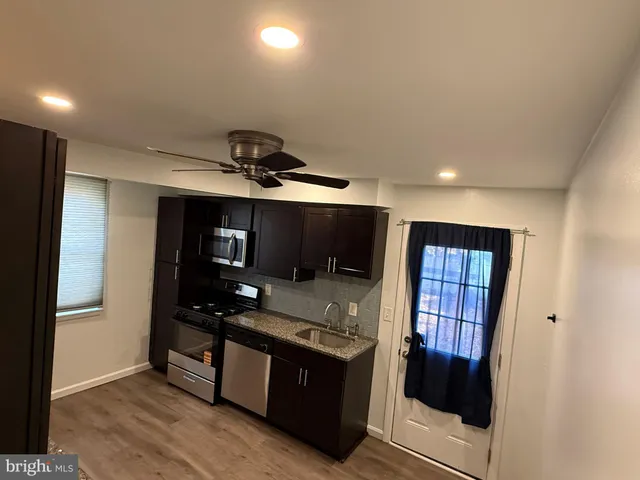 a kitchen with stainless steel appliances granite countertop a stove and a refrigerator