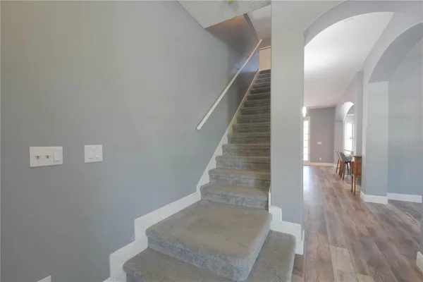 a view of entryway and hall with wooden floor