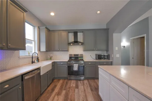 a kitchen with a sink dishwasher a stove and a refrigerator