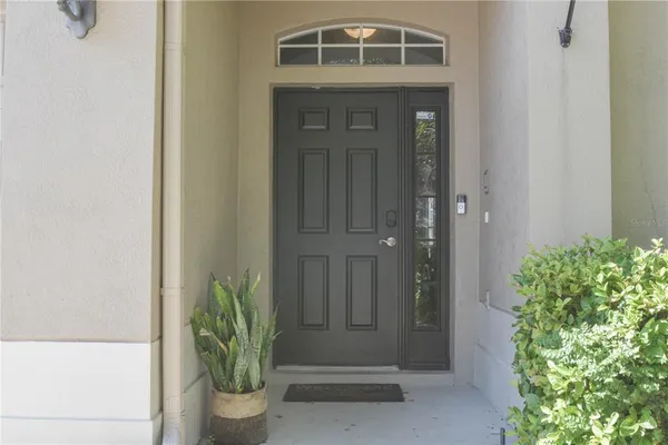 a front view of a house with a potted plant