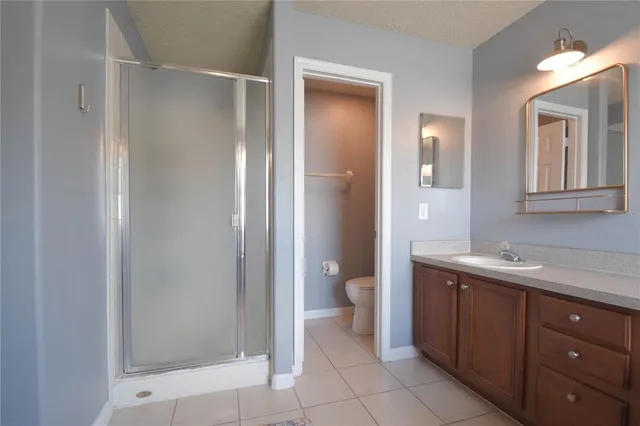 a spacious bathroom with a toilet sink and shower