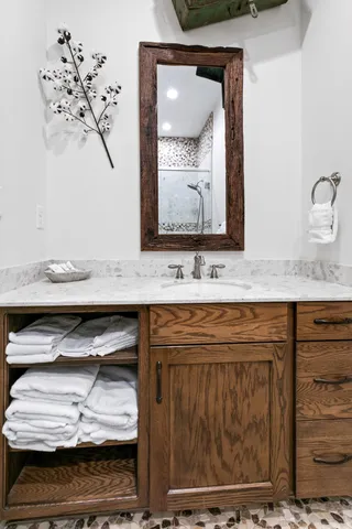 a bedroom with a bed and a flat tv screen on the dresser