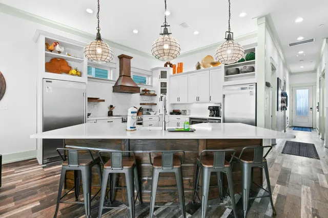 a kitchen with kitchen island granite countertop a sink a center island and cabinets