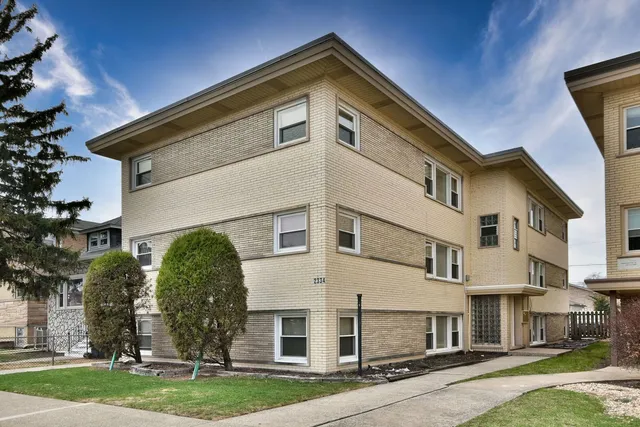 a view of a white building among the street with a building