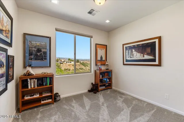 a view of workspace with furniture and window