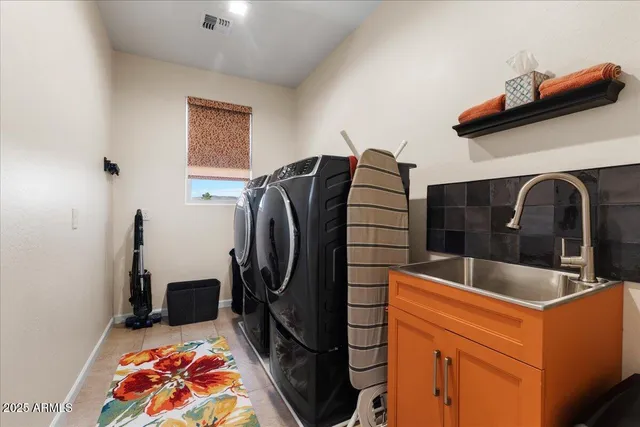 a kitchen with stainless steel appliances granite countertop a sink and refrigerator