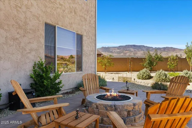 a view of a patio with couches table and chairs and potted plants