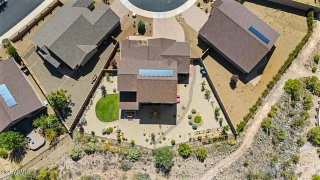an aerial view of a house with a yard and potted plants
