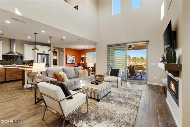 a living room with furniture wooden floor and a flat screen tv