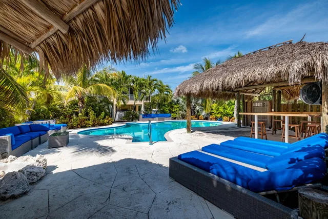 a kitchen with stainless steel appliances granite countertop a sink refrigerator and cabinets