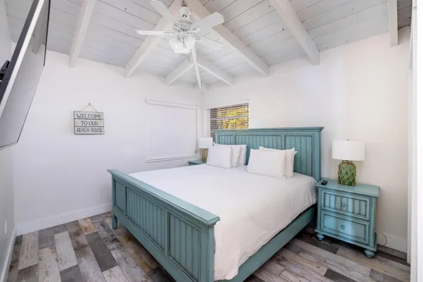 a bedroom with a bed and a flat screen tv