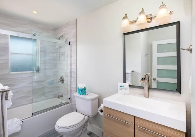 a bathroom with a toilet a sink and shower