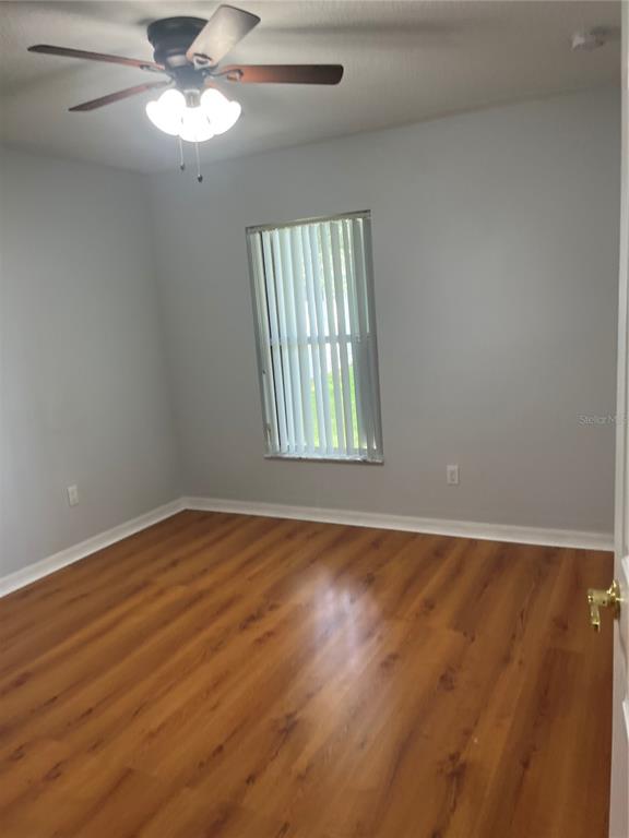 12 Prairie Lane Palm Coast, FL 32164 - Photo 13 of 41 an empty room with wooden floor fan and windows