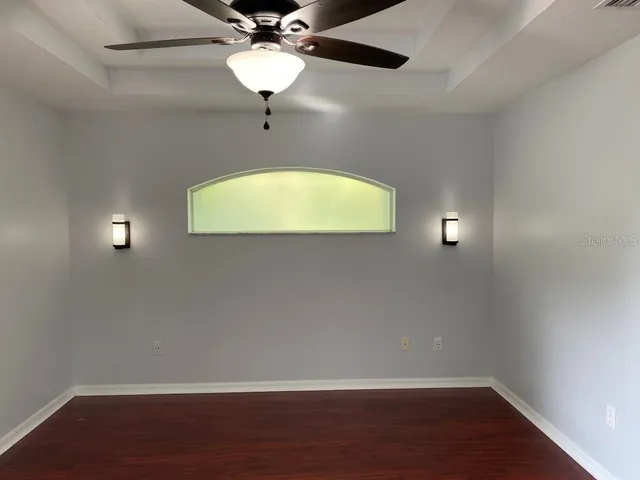 a view of a room with wooden floor and windows
