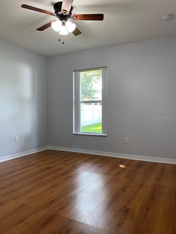12 Prairie Lane Palm Coast, FL 32164 - Photo 18 of 41 a view of an empty room with wooden floor and a window