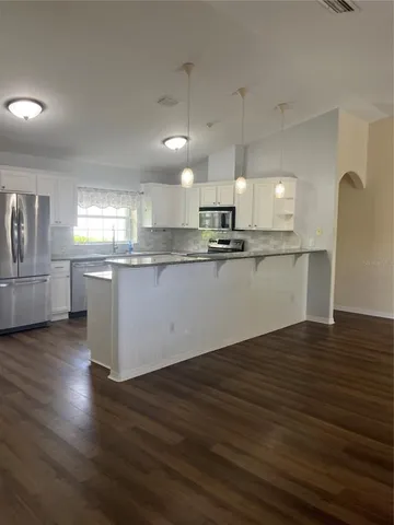a view of walk in closet with wooden floor